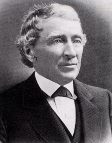 Black and white photograph of an older man, Jesse Fell, wearing a simple suit. He has a nice gaze, looking off into the distance, and a slight upward turn to his mouth