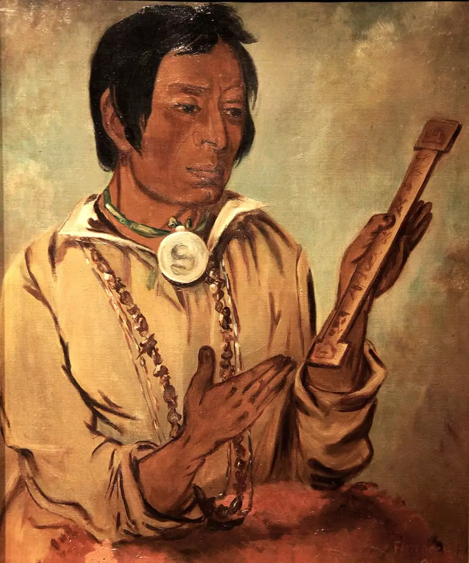 Painted image of a chief, decorated in several necklaces, holding a wooden prayer stick.