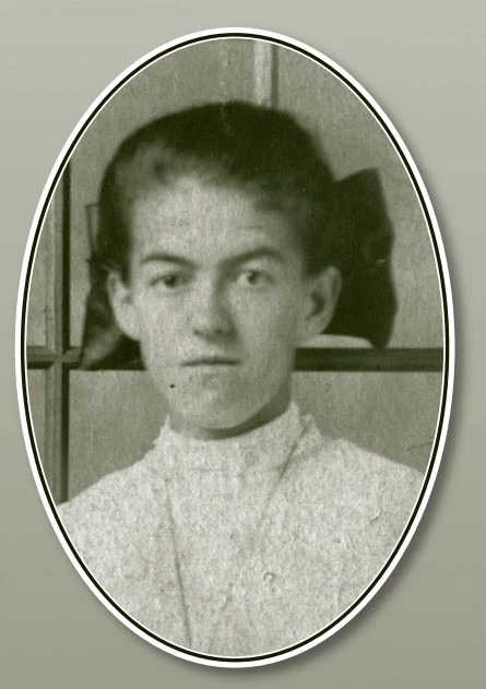 portrait of a light-skinned young woman. Her hair is pulled back and she is wearing a large bow that sticks out on both sides of her head. She stares into the camera with a serious look.