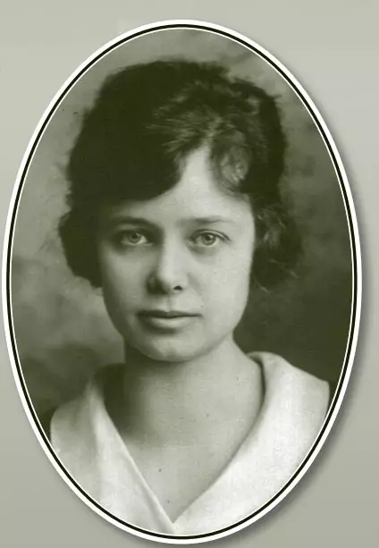 Portrait of a young light-skinned woman with short wavy hair. She is looking directly into the camera with a relaxed face.