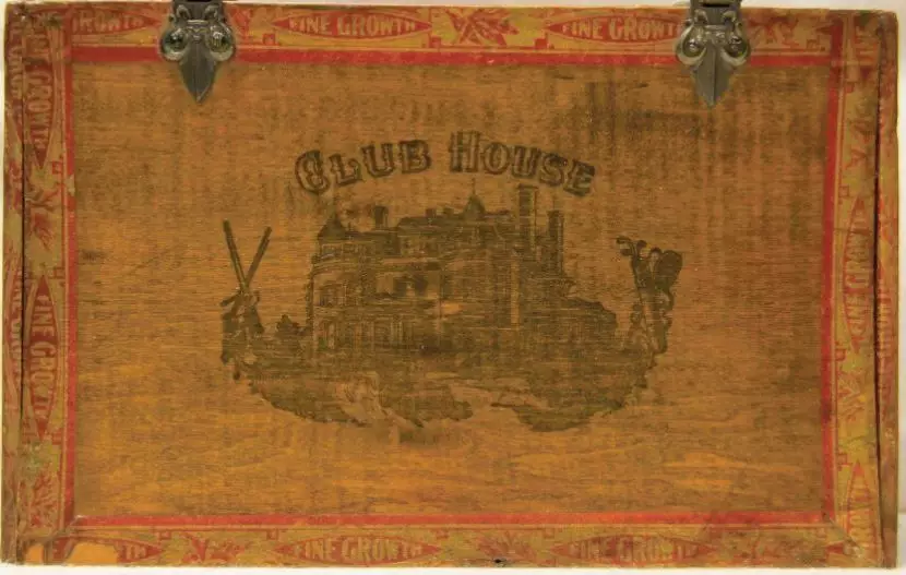 An brown cigar box with Club House printed on it. It features an outline picture of a manor.