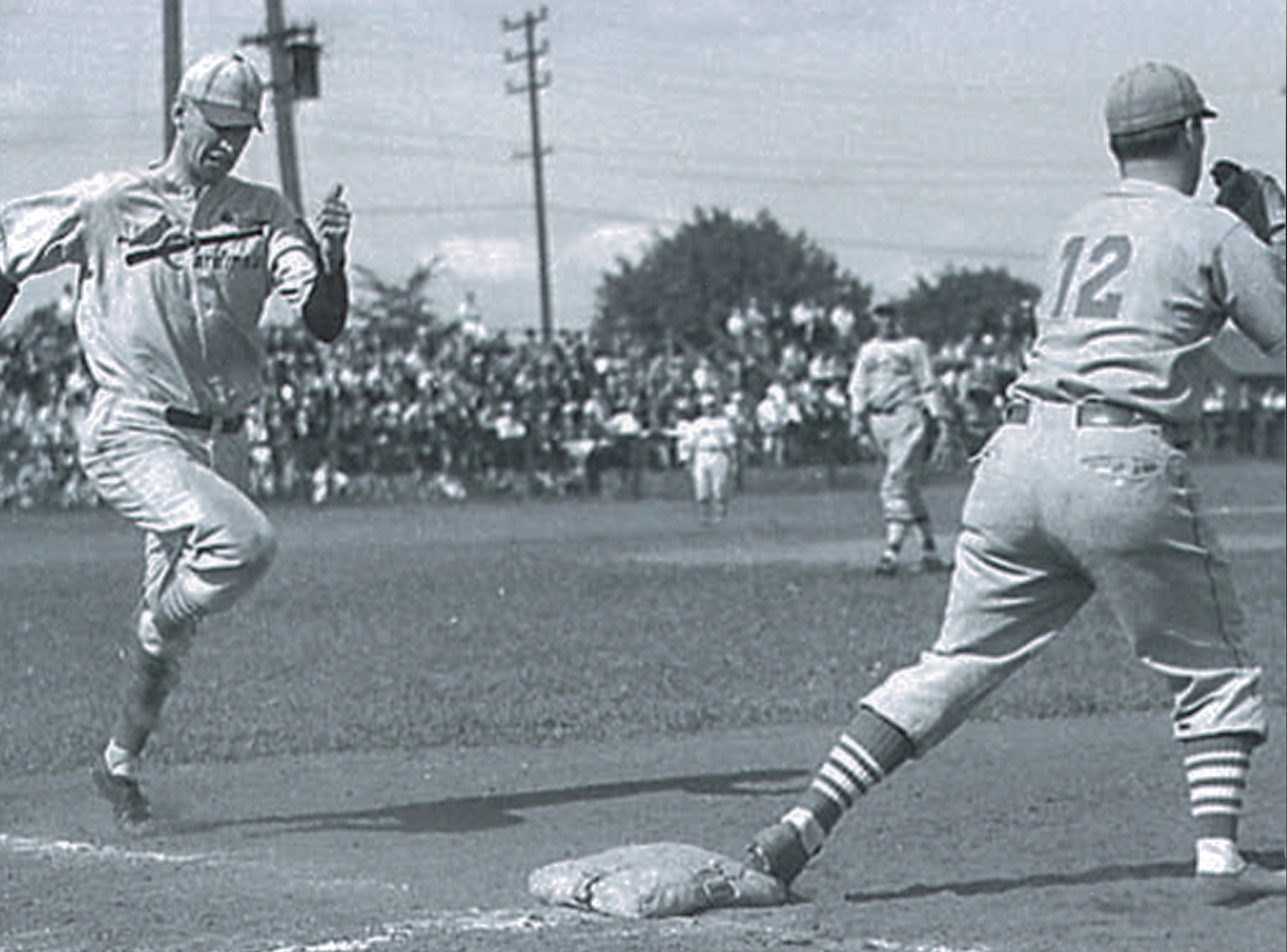 shortstop Bing Cosbey attempting to beat out a second-inning grounder