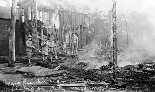 soldiers standing in smoking rubble